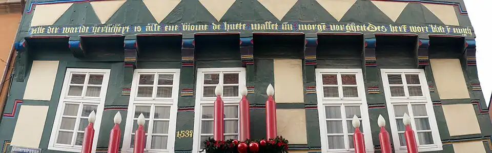 Inscription in Middle Low German on a house at Hameln: "Alle der warlde herlicheyt is alse ene blome de huete wasset un morgen vorgheit. Des herrn wort blift yn ewicheit." (All the world's magnificence is like a flower that grows today and vanishes tomorrow; the Lord's word remains in eternity.)