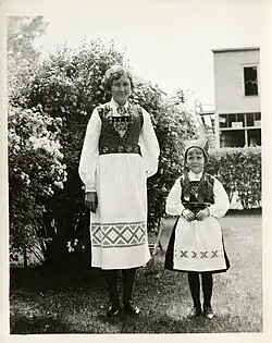 Mother and daughter posing for a picture in their traditional Norwegian bunad during the Norse-American Centennial celebration.