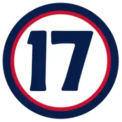 The number "17" in navy blue set against a white circle with a red and navy border
