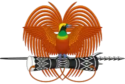 A stylised bird-of-paradise standing on a spear and kundu drum