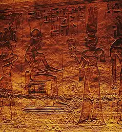 Nefertari offering sistra to seated goddess Hathor. Frieze inside the Small Temple.