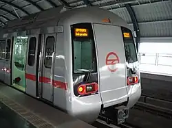 Older, but still modern, rapid-transit train at a station