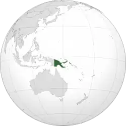 Papua New Guinea in green with Southeast Asia and other areas of Asia to its west and northwest, Australia to the south, and the large Pacific ocean to the east