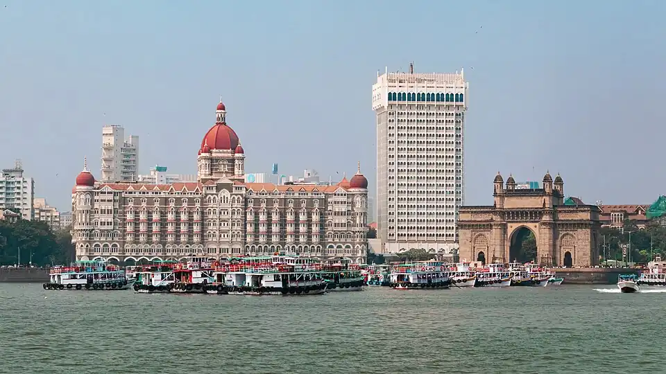 Mumbai, the centre of India's tertiary sector finance industry, also contributes to tourism. Shown here are the Taj Mahal Palace Hotel to the left and the Gateway of India.