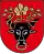 A coat of arms depicting the black head of a bull with a golden vine entangled in its black horns and a golden ring protruding from its nose