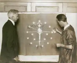 Paul Hadley (left) with the flag that was given to the state, 1923.