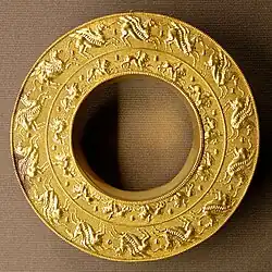 Reel (probably an ear-stud) with representations of Pegasus and Chimaira