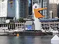 A barge decorated to look like a pelican carrying a jumbotron display, Sydney