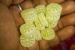 several pieces of hard sugar candy in someone's hand