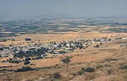 Photograph of a small town and farms taken from an elevation