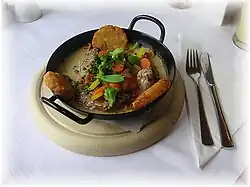 A traditional Austrian pork dish, served with potato croquettes, vegetables, mushrooms and gravy