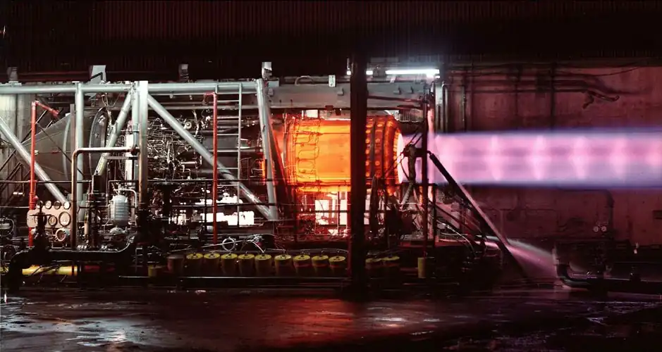 This picture of an uninstalled engine being tested illustrates the need for cooling air around the exhaust duct. The engine, when installed as part of the powerplant, has secondary cooling air at 1,200&nbsp;°F (650&nbsp;°C) passing over the afterburner duct which is heated internally by combustion up to 3,200&nbsp;°F (1,750&nbsp;°C). The heating, followed by the primary nozzle restriction, accelerates the exhaust to sonic speed as it leaves the primary nozzle (shown). The ejector nozzle (not shown) surrounds the primary exhaust with secondary and tertiary air to cushion its expansion in the ejector nozzle.