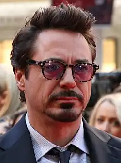 Downey wearing glasses, looking sternly forward