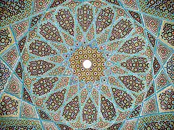 Geometric arabesque tiling on the underside of the dome of Hafiz Shirazi's tomb in Shiraz, Iran
