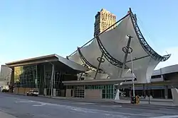A photo of the Rosa Parks Transit Center, a sleek, modern building with a sweeping canopy design.