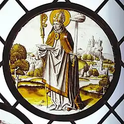 Renaissance roundel using only black or brown glass paint, and silver stain. The bishop-saint Lambrecht of Maastricht stands in an extensive landscape, 1510–20. Diameter 8+3⁄4&nbsp;in (22&nbsp;cm). Designed to be placed low, close to the viewer.