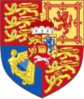 A coat of arms that comprises a shield in four quadrants. There is a second smaller shield in the centre of the four quadrants, which itself contains three sections and a crown in the centre, as well as a crown on top of the inner shield.