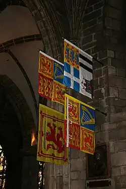 The Royal Standard of the United Kingdom (Scottish variant) and (clockwise) those of the Prince Philip, the Princess Royal (Scottish variant) and the Duke of Rothesay, displayed in St Giles's Cathedral.