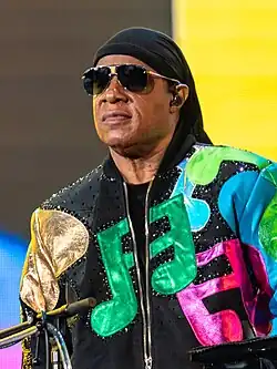 Stevie Wonder with a colorful jumper wearing sunglasses