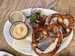 Pretzels served with Camembert-beer cheese and fresh red onion in Salzburg, Austria tavern