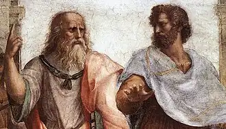 Photo of a fresco of two men in robes gesturing as part of a discussion