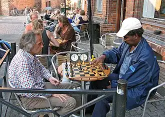 Two men play chess at the Ariman cafe in Lund in 2007
