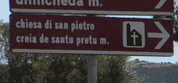 Bilingual sign pointing to a church