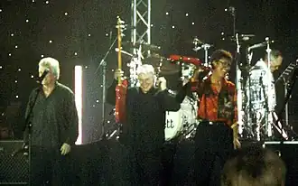 The Shadows performing in Denmark in 2007, featuring long-time members from left Bruce Welch (far left), Mark Griffiths and Hank Marvin; Brian Bennett featured in background on drums.