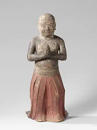 Statue of Shōtoku as a child, with hands pressed together in worship. Circa 1200–1350 CE