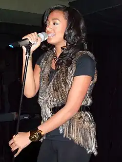Solange performing behind a microphone