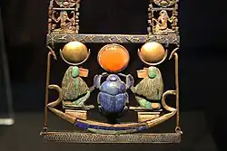 Pectoral of a scarab in a solar barque flanked by baboons