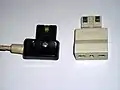 Magic Security plug (10&nbsp;A) (left) with a Type&nbsp;L to Magic Security plug adaptor