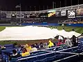 The grounds crew taking the tarp off the infield