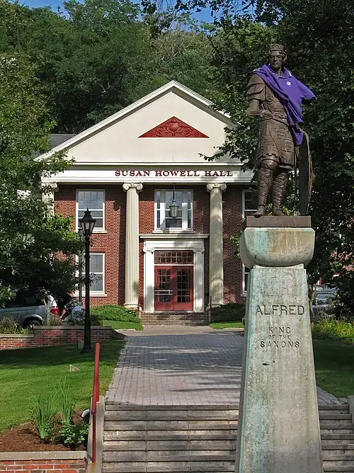Statue of Alfred at the center of Alfred University's quad in Alfred, New York. The statue is often decorated by students; in this instance, it was dressed in a purple Orientation Guide shirt for freshman orientation.