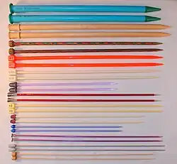 Knitting needles in a variety of sizes and materials. Different materials have varying amounts of friction, and are suitable for different yarn types.