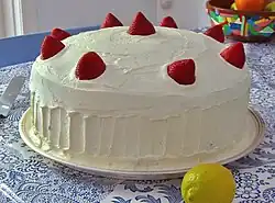 A large cake garnished with strawberries