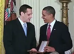 Stuart Milk speaks with Barack Obama, holding the case for the Presidential Medal of Freedom in the White House