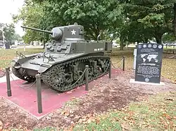 Photo shows an M3 Stuart tank painted dark green.