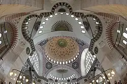 The Süleymaniye Mosque (1550–7), evokes the Hagia Sophia's design with a central dome and two semi-domes.[101]