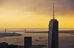 One World Trade Center seen at sunset; the Verrazzano–Narrows Bridge is in the background