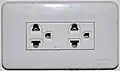 An earthed Thai socket that complies with figure&nbsp;4 of TIS&nbsp;166-2549. Although it accepts NEMA plugs, the Thai voltage is 230&nbsp;V and thus is electrically incompatible with devices designed only for 120&nbsp;V.
