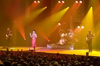 The Cranberries performing in Paris, France in 2010. From left to right: Noel Hogan, Dolores O'Riordan, Fergal Lawler, and Mike Hogan.