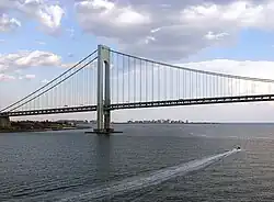 View of the Verrazzano–Narrows Bridge looking south from Upper New York Bay. The neighborhood of Coney Island in Brooklyn can be seen in the distance.