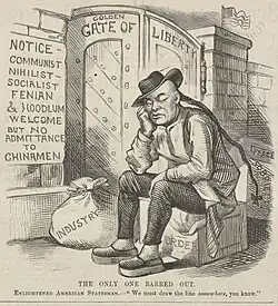 A Chinese man sitting outside a locked gate