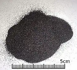 A small heap of uniform black grains smaller than 1mm in diameter