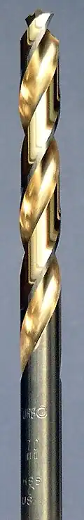 A steel colored twist drill bit with the spiral groove colored in a golden shade