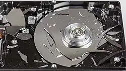 Destroyed hard disk, glass platter visible