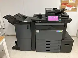 A photo of a black Toshiba office laser printer.