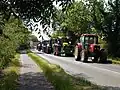 A charity fund-raising tractor run passes through Glinton, UK
