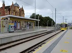 alt=A photograph of rails at a train station.